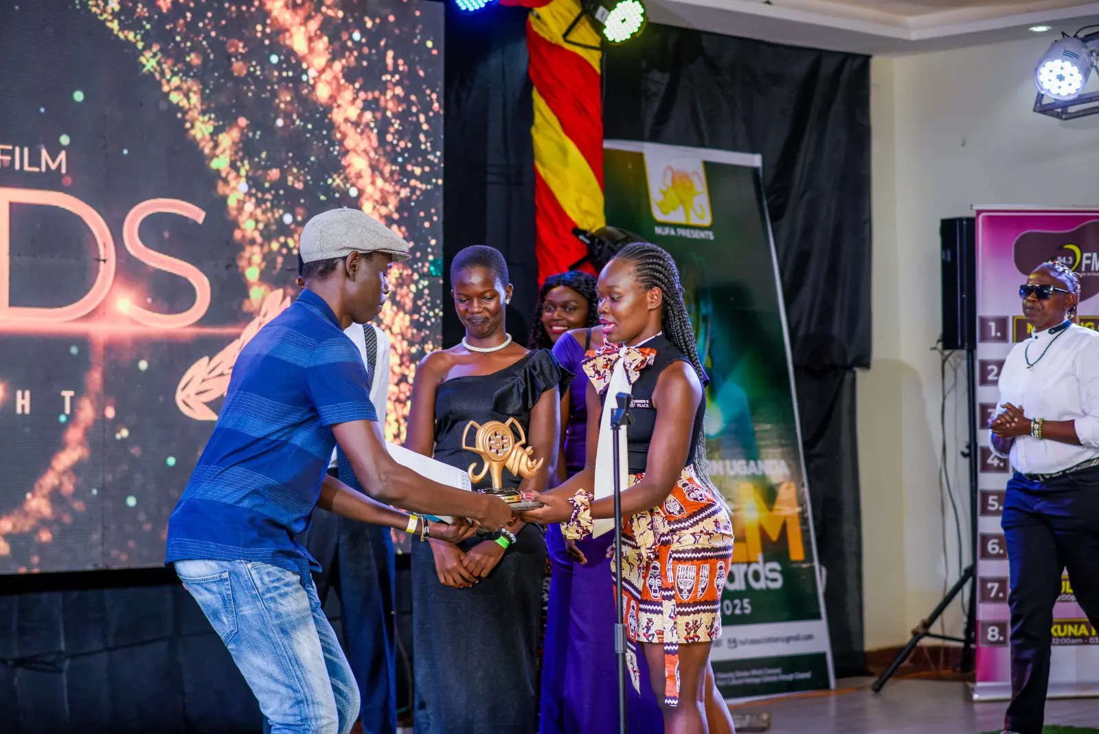 A trophy is presented on stage at NUFA25