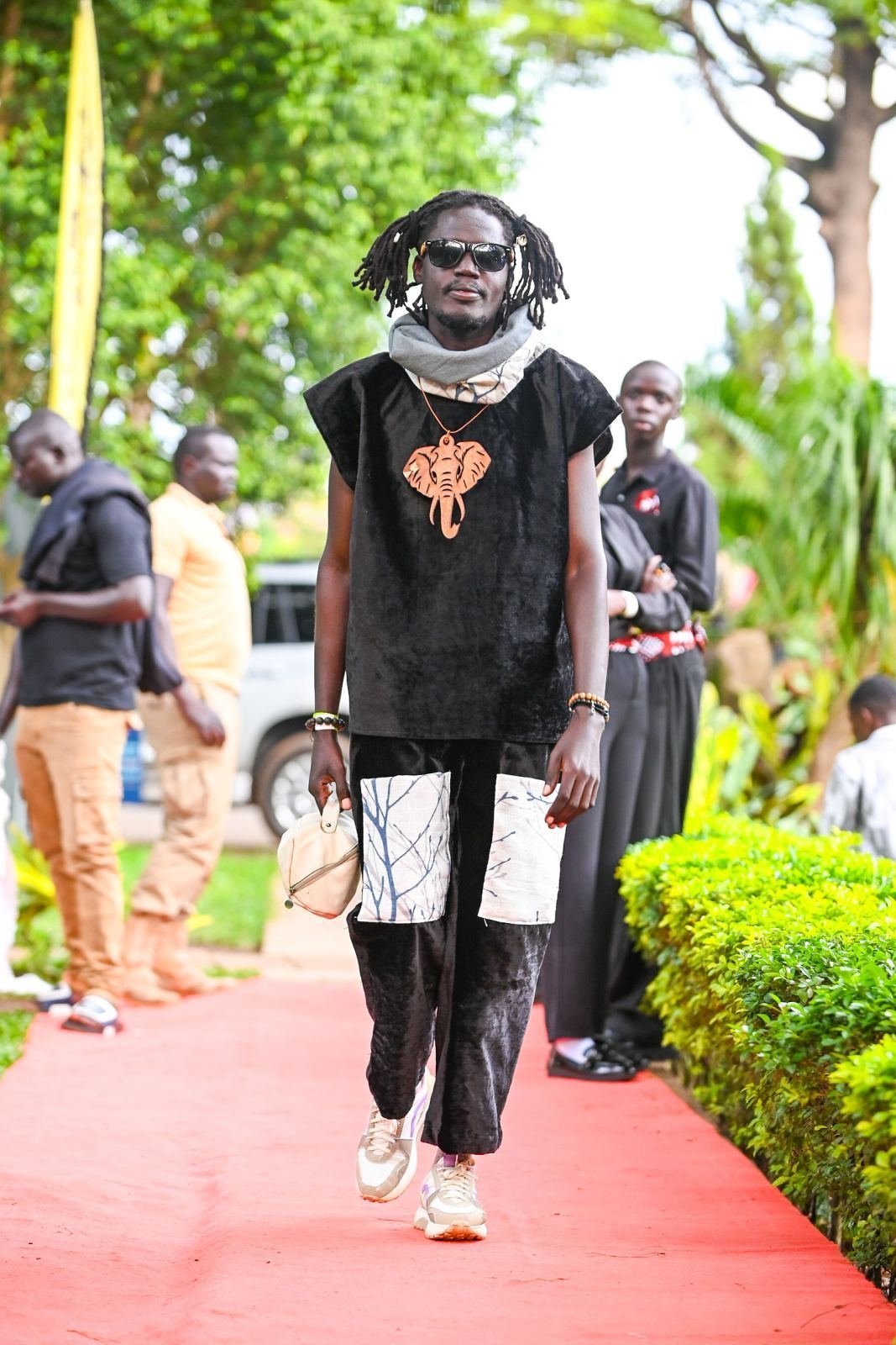 A filmmaker in cultural dress with an elephant-motif pendant at the NUFA26 Awards